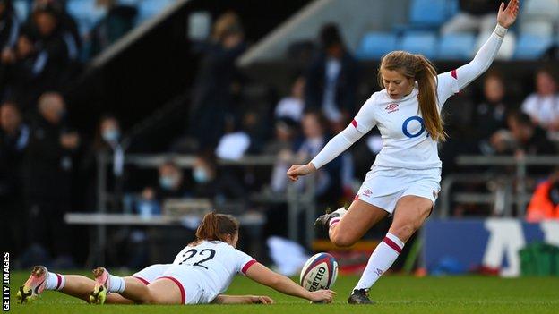 Zoe Harrison kicks at goal