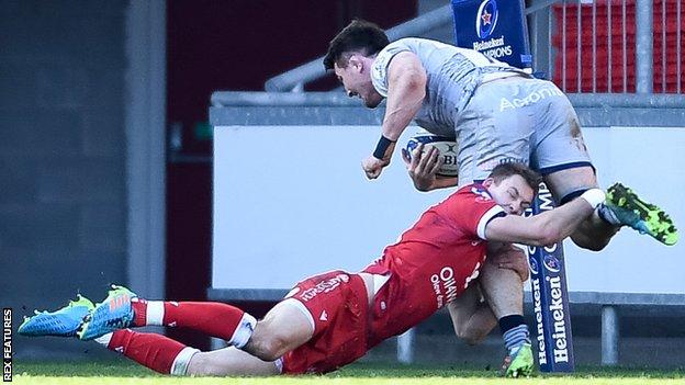 Sale's Tom Curry is tackled by Liam Williams of Scarlets