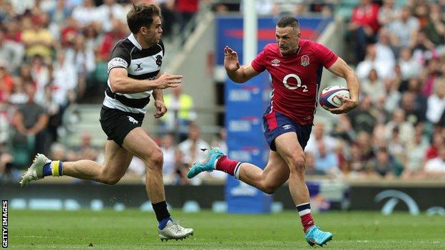 Jonny May of England takes on Damian Penaud