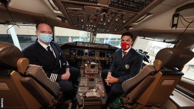 Conor Murray sits alongside a plane captain in the cockpit