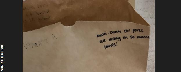 A brown paper bag reading 'Multi-story car parks are wrong on so many levels'