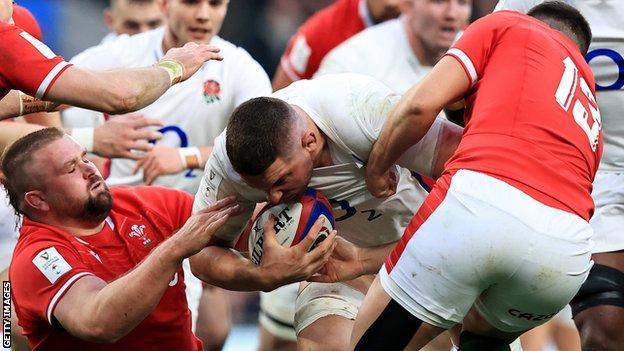 Tomas Francis (L) reels after colliding with Owen Watkin (R) while they attempt to tackle Charlie Ewels