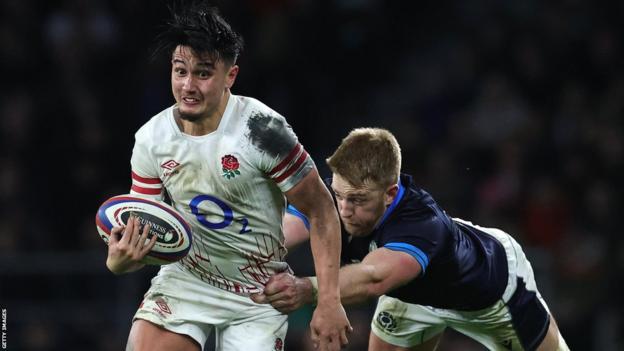 Marcus Smith runs as a Scotland player tries to tackle him