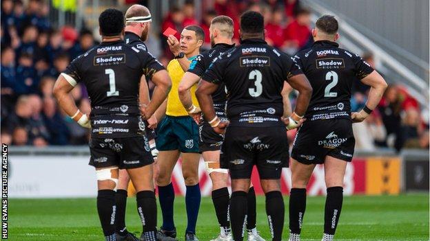 Dragons lock Joe Davies is shown a red card by referee Craig Evans